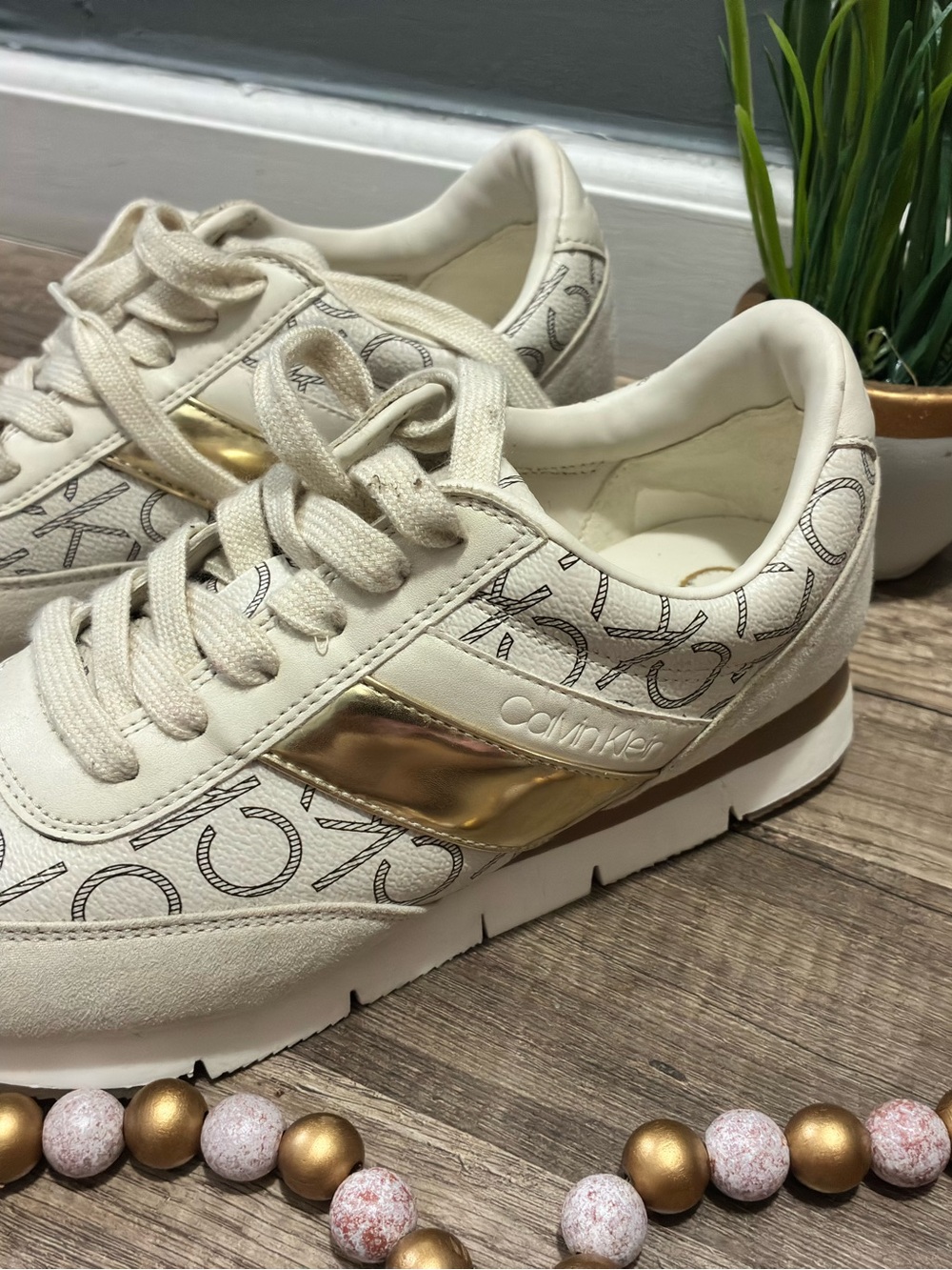 Calvin Klein Cream Sneakers with Gold Accent and Logo Print